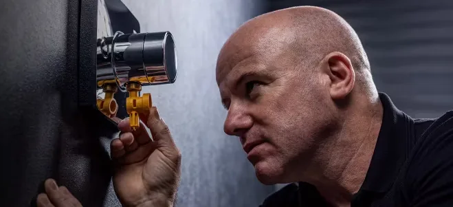 An engineer inspecting a Rada shower valve
