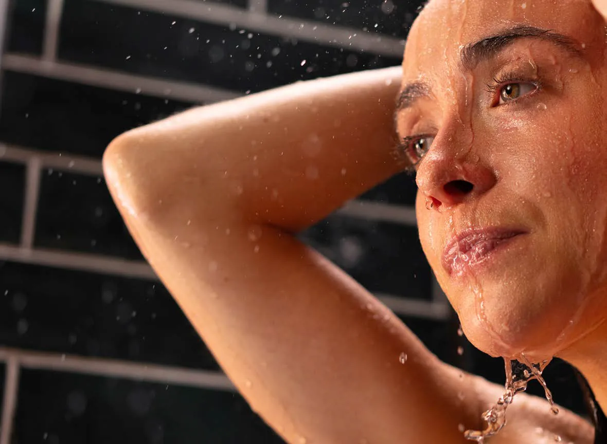 A person enjoying a warm, water-efficient shower